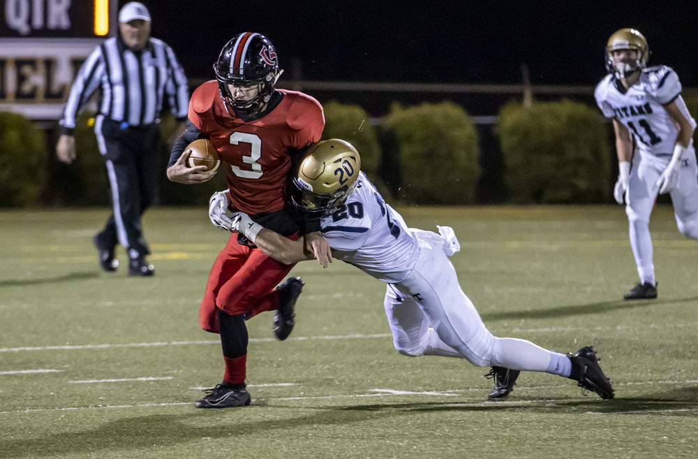 Hidden Valley's (20) Matt Strong brings wraps up Cave Spring's (3) Lucas Duncon. Hidden Valley's (11) Cross Thompson trails the play.